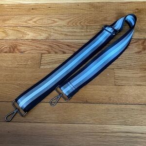 Adjustable striped bag strap small flaw on inside not noticeable good quality.